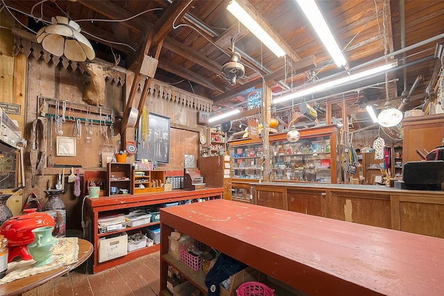 miscellaneous room with hardwood / wood-style flooring and wooden walls