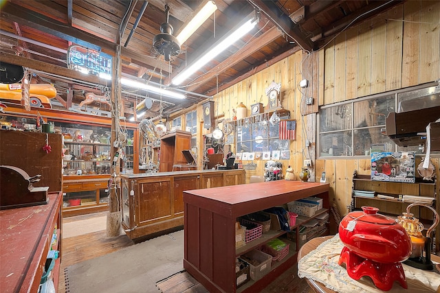 kitchen featuring wood walls, hardwood / wood-style floors, and wooden ceiling