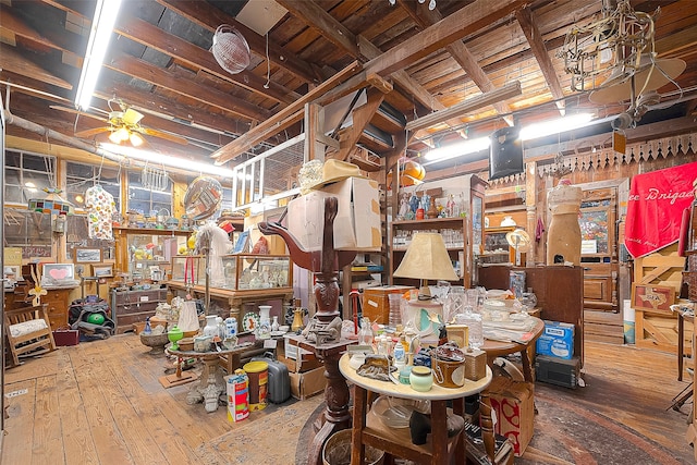 basement with ceiling fan, wood-type flooring, and wooden ceiling