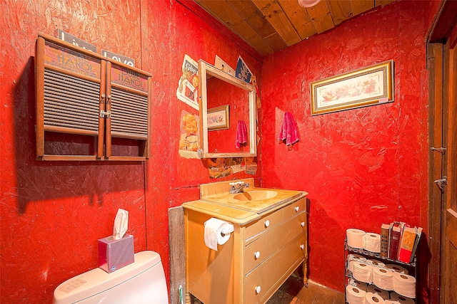 bathroom featuring vanity, toilet, and wooden ceiling