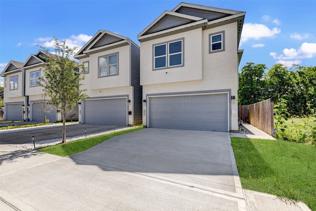 view of front of house featuring a garage and a front lawn