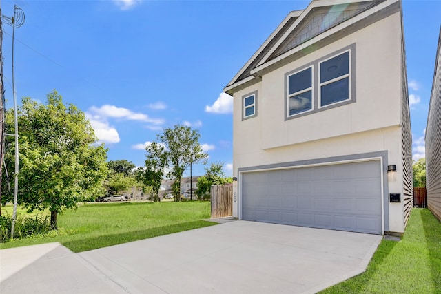 view of front of property featuring a garage and a front lawn