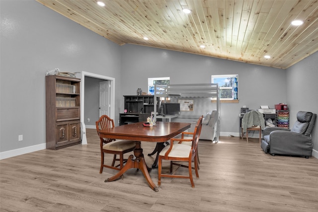 dining area featuring light wood-type flooring, wooden ceiling, and high vaulted ceiling