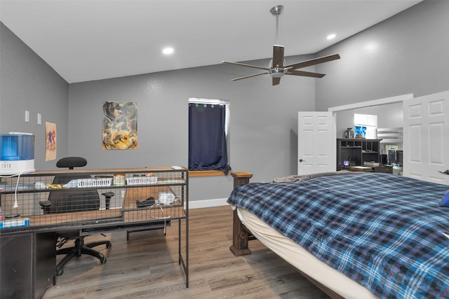 bedroom with ceiling fan, hardwood / wood-style flooring, and high vaulted ceiling