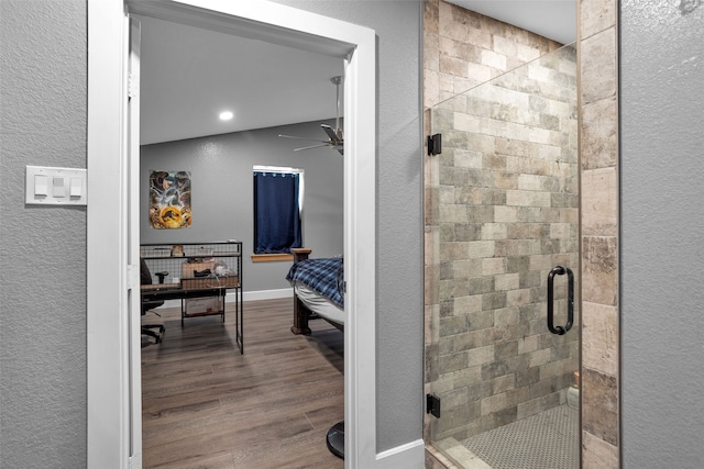 bathroom featuring an enclosed shower, ceiling fan, and wood-type flooring