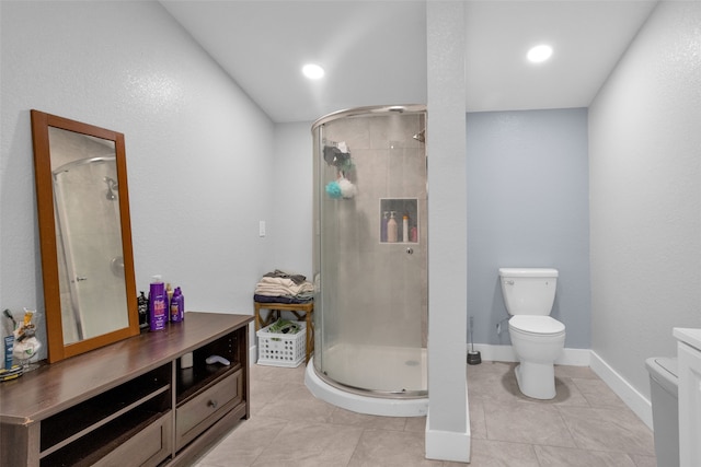 bathroom featuring tile patterned flooring, a shower with shower door, toilet, and vanity