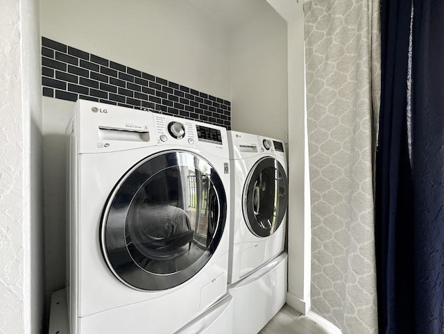 clothes washing area with washer and dryer