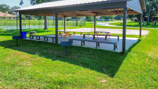 view of property's community featuring a yard and volleyball court