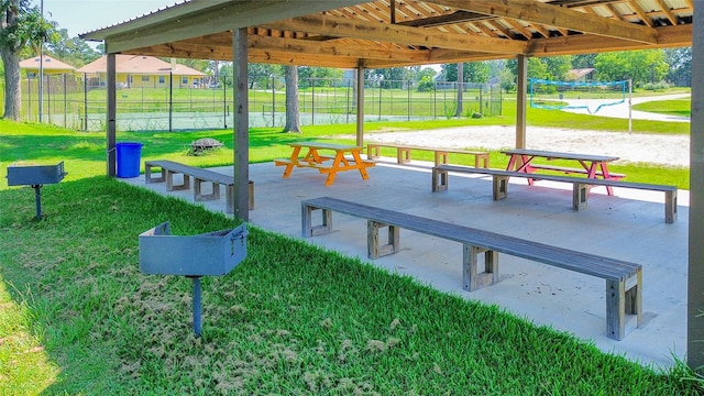 view of home's community featuring volleyball court and a yard