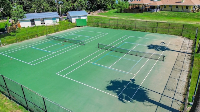 view of sport court with a yard