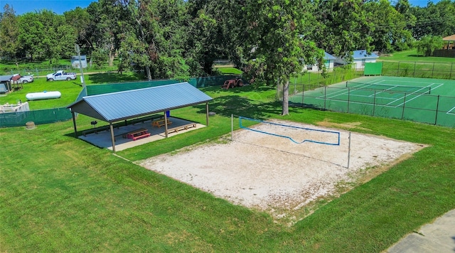 view of community with volleyball court, a gazebo, and a lawn