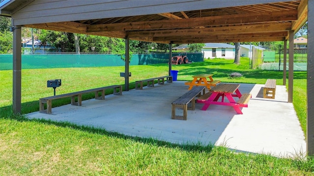 exterior space featuring a lawn, a water view, and a patio