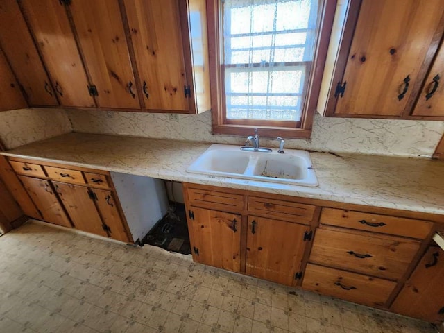 kitchen with sink and light tile flooring