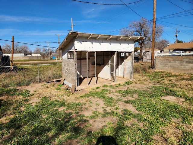 back of property featuring an outdoor structure