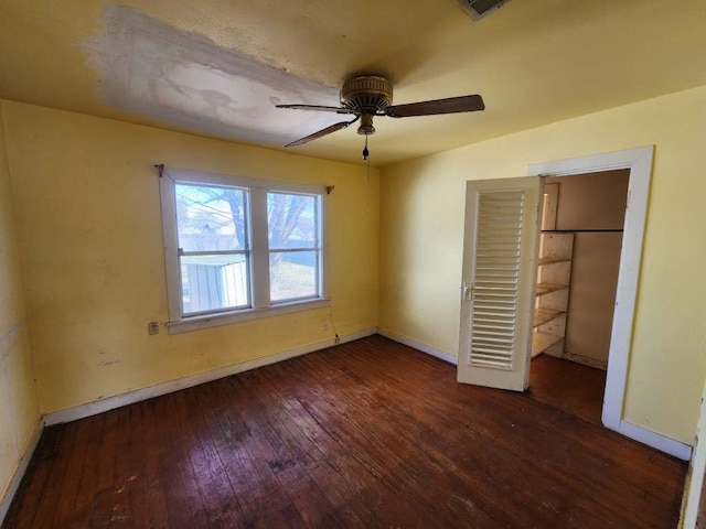 unfurnished bedroom featuring a closet, ceiling fan, and dark hardwood / wood-style flooring