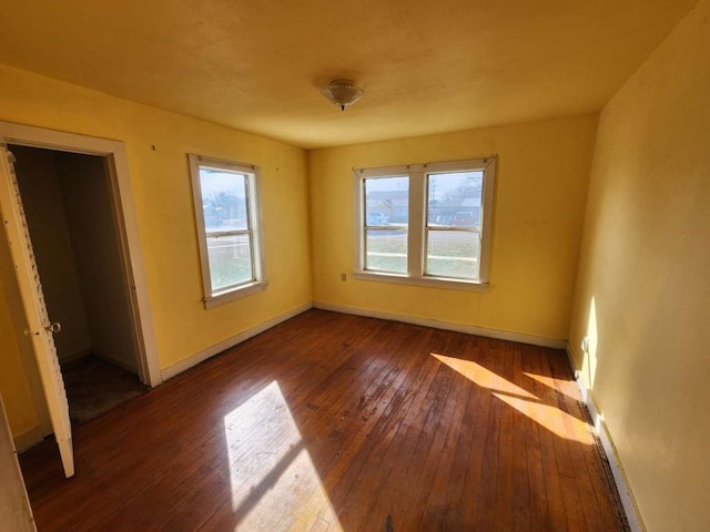 unfurnished bedroom featuring dark hardwood / wood-style floors