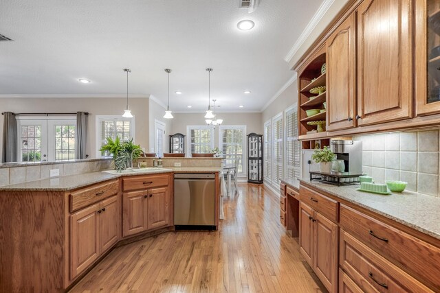 kitchen featuring dishwasher, french doors, sink, tasteful backsplash, and decorative light fixtures