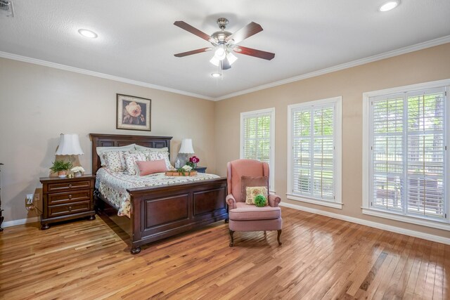 bedroom with ceiling fan, light hardwood / wood-style flooring, and ornamental molding