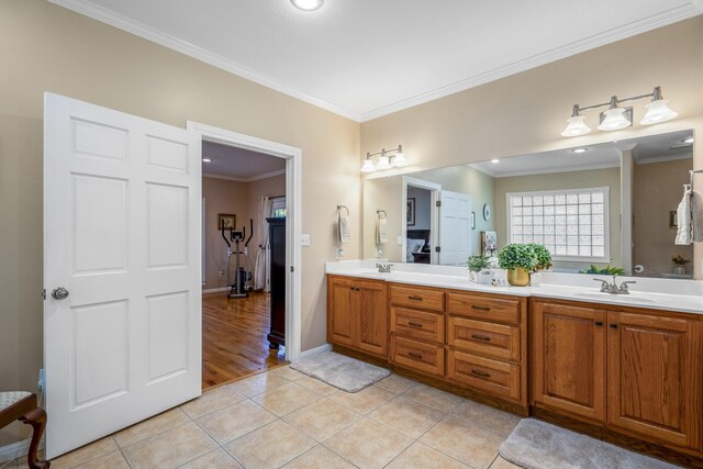 bathroom featuring tile patterned flooring, vanity, and crown molding