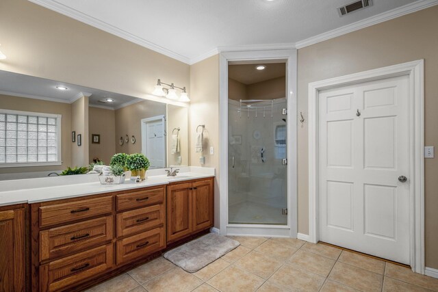 bathroom with vanity, tile patterned floors, a shower with door, and ornamental molding