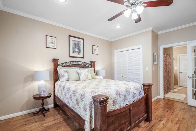 bedroom featuring ceiling fan, a closet, crown molding, and hardwood / wood-style flooring