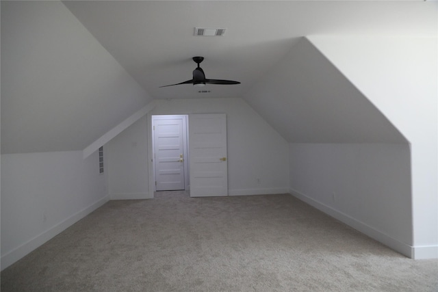 bonus room featuring ceiling fan, light carpet, and vaulted ceiling