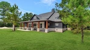 rear view of house featuring a lawn