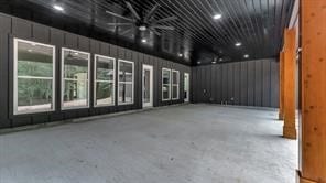 spare room with ceiling fan and concrete floors