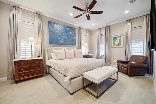 carpeted bedroom featuring ceiling fan, crown molding, and multiple windows