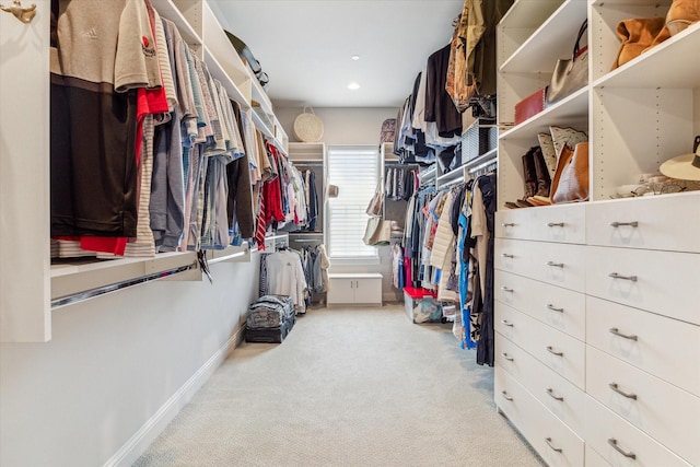 walk in closet featuring light carpet