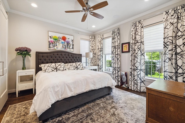 bedroom with ceiling fan, crown molding, dark hardwood / wood-style floors, and multiple windows