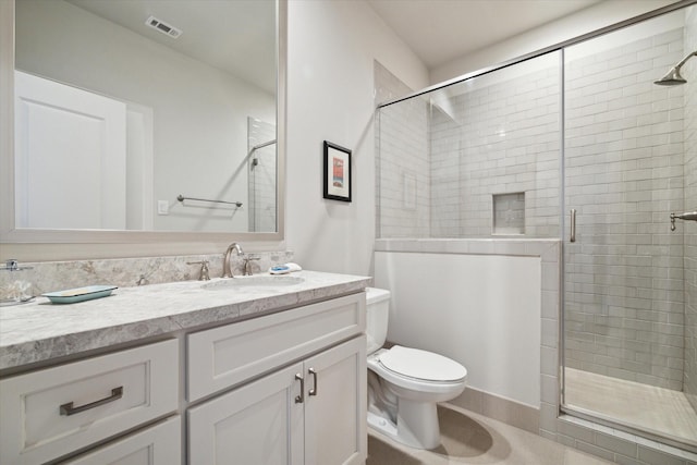 bathroom with a shower with door, toilet, and vanity