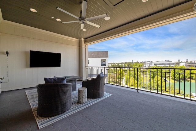 view of patio with ceiling fan and a balcony