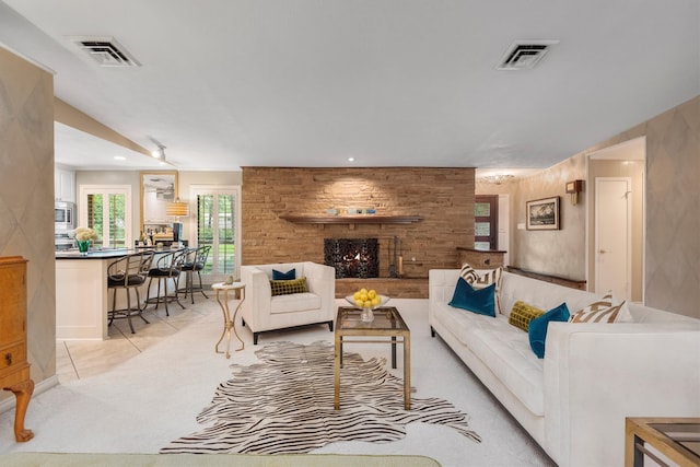 living room featuring a fireplace and light carpet