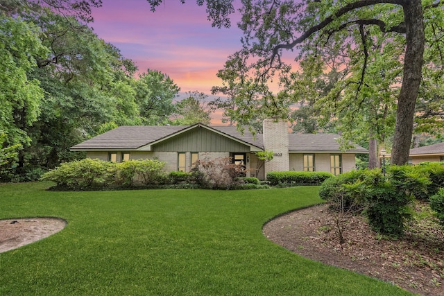 back house at dusk with a yard