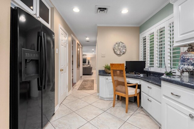 kitchen featuring ornamental molding, white cabinets, light tile flooring, and black fridge with ice dispenser