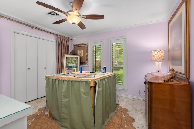 tiled bedroom featuring ceiling fan, ornamental molding, and a closet