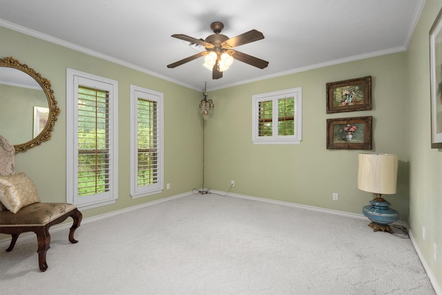 sitting room with ceiling fan, carpet floors, and ornamental molding