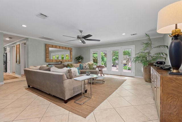 living room featuring crown molding, light tile flooring, and ceiling fan