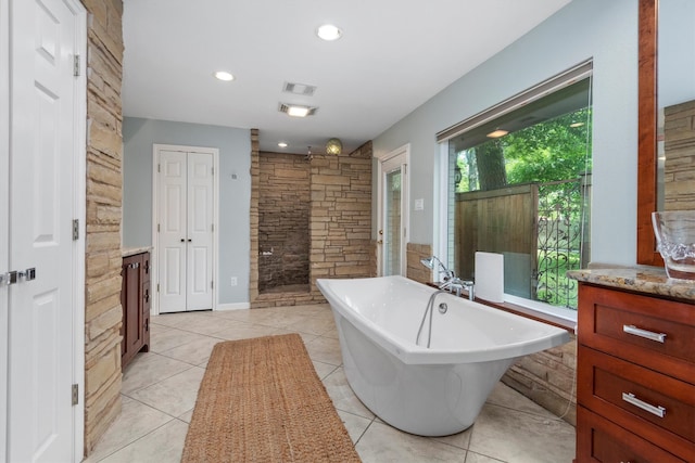 bathroom with separate shower and tub, vanity, and tile floors