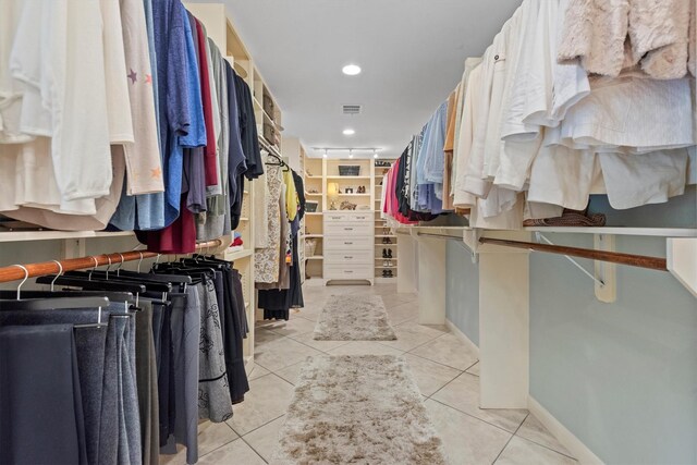 walk in closet featuring light tile floors