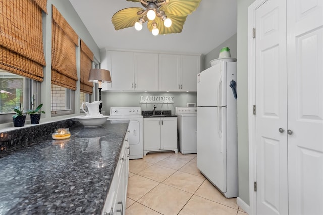 kitchen featuring washer / dryer, white cabinetry, and white fridge