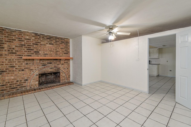 unfurnished living room with ceiling fan, light tile patterned floors, and a brick fireplace