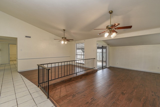 empty room with ceiling fan, wood-type flooring, and lofted ceiling