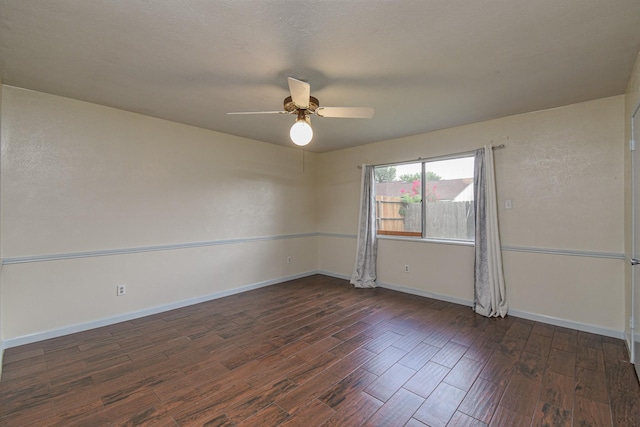 spare room featuring dark hardwood / wood-style floors and ceiling fan