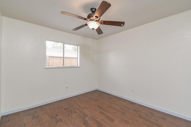 spare room featuring dark hardwood / wood-style floors and ceiling fan