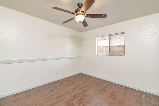 spare room featuring dark hardwood / wood-style floors and ceiling fan