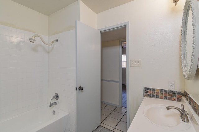 bathroom with tile patterned flooring, vanity, and tiled shower / bath combo