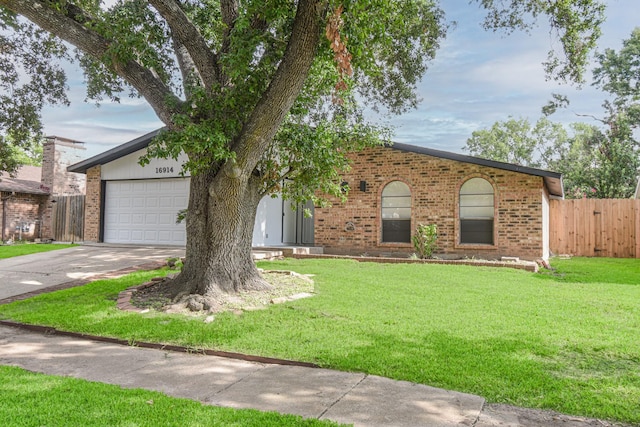 ranch-style home with a garage and a front lawn