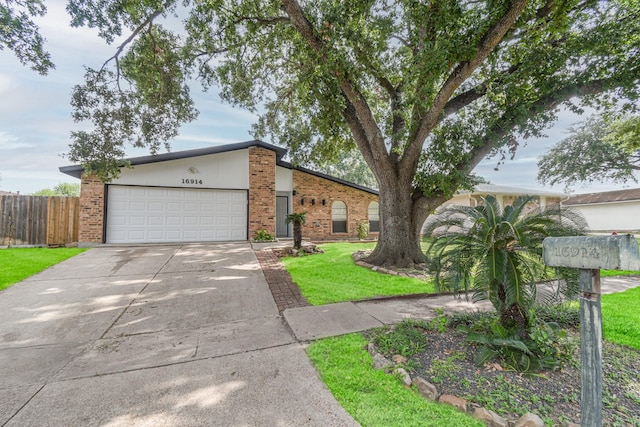 single story home featuring a front lawn and a garage